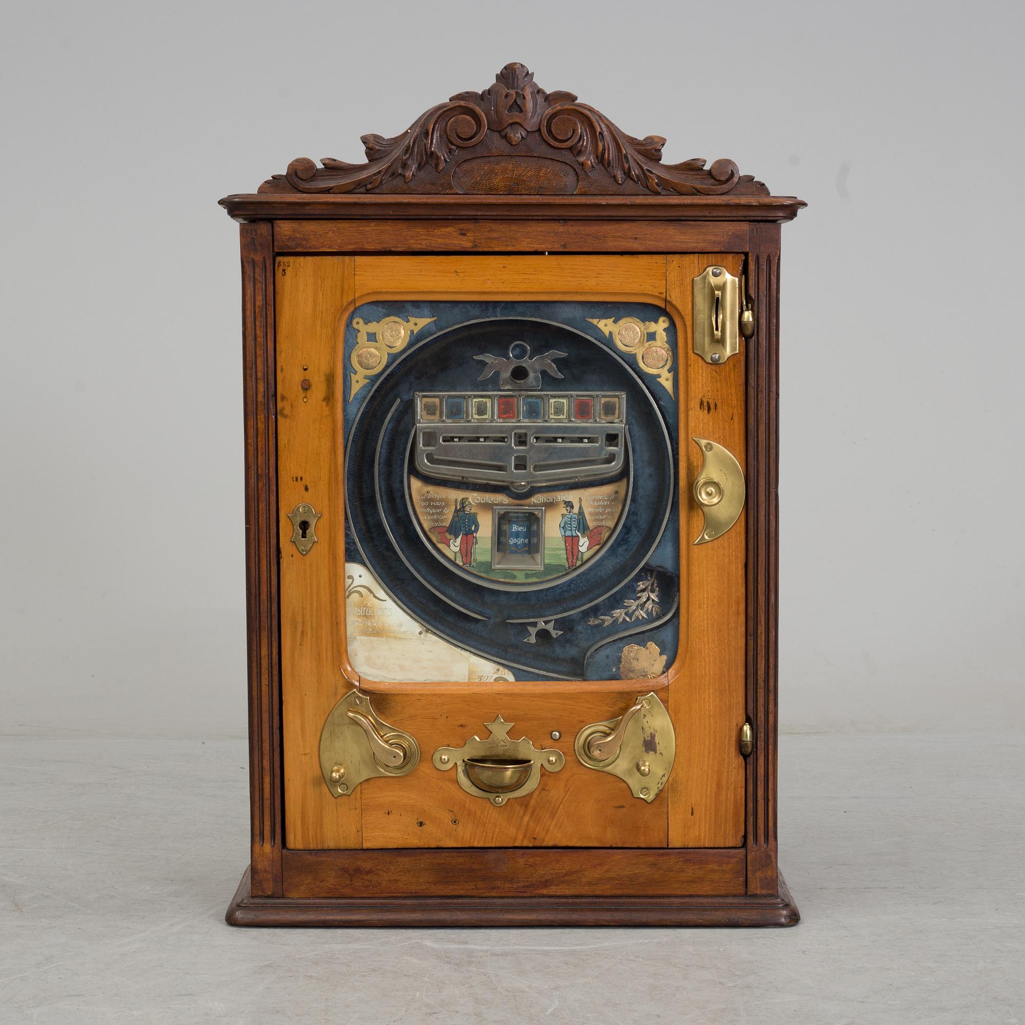 A 'Coleurs Nationales' Bussouz slot machine, Paris, France, circa 1900.