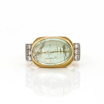 RING, 18K guld med åttkantslipade diamanter ca 0,12 ct och cabochonslipad grön turmalin, ca 8,04 ct. Vikt ca 8,01 g.