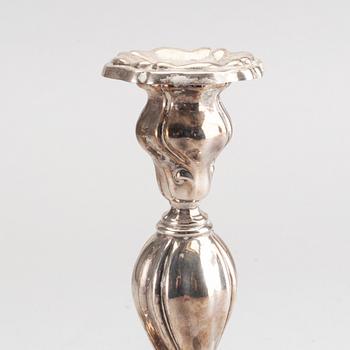 A 20th century pair of silver candle sticks rococo-style, height ca 22 cm.