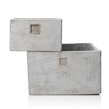 A pair of conpemporary concrete flower pots.