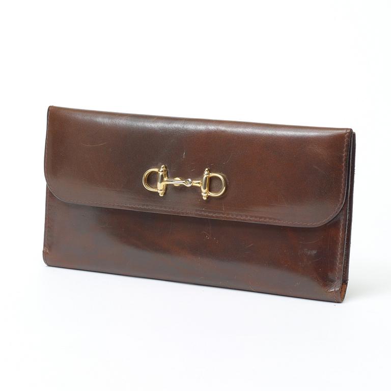An darkbrown leather evening bag/wallet by Celine.