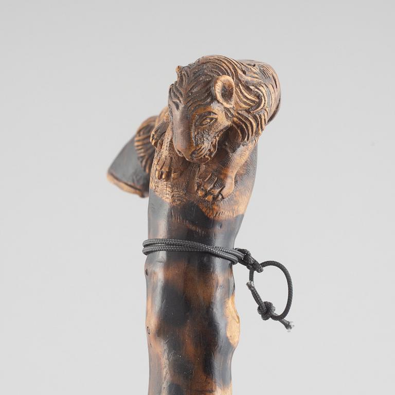 A carved wooden cane, 19th century.