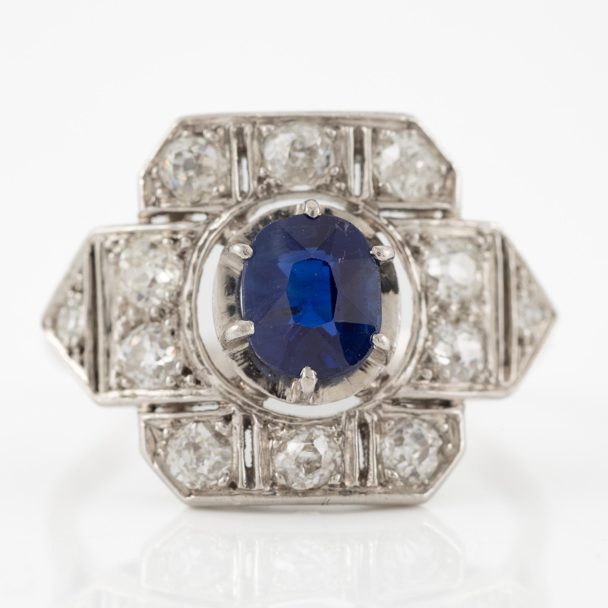 Platinum ring with sapphire and old-cut diamonds.