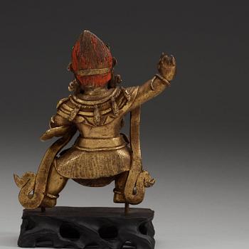 A Sinotibetan gilt bronze  figure of a Dharmapala.