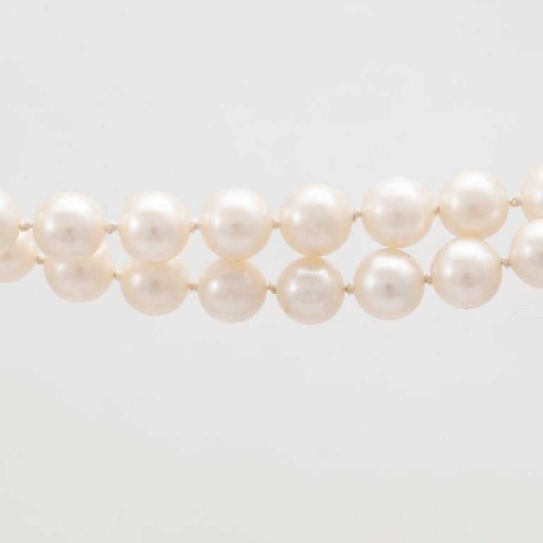 A two row cultured pearl necklace with 14K gold clasp.