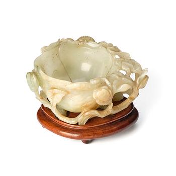 986. A carved Chinese nephrite cup in the shape of a lotus leaf, late Ming dynasty.