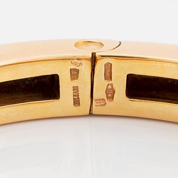 An 18K gold Bulgari bangle.