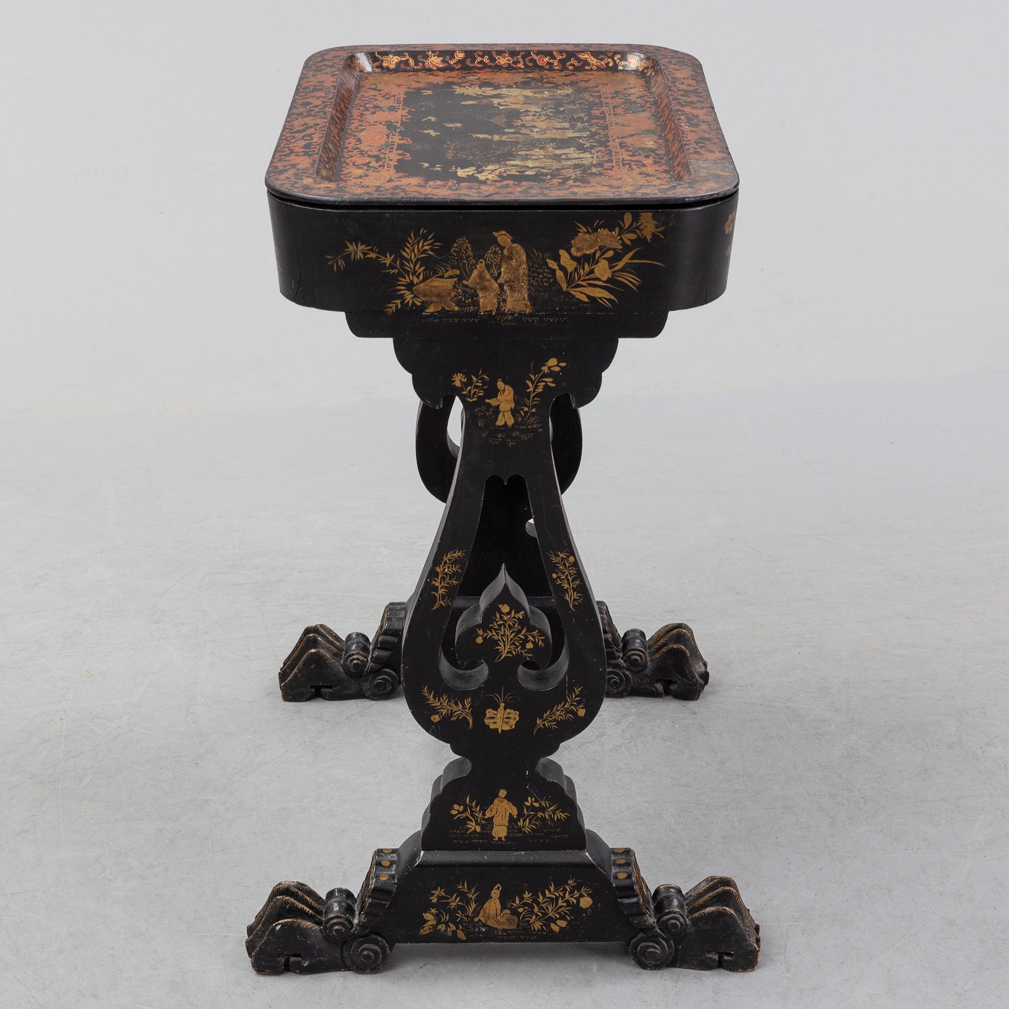 A black chinoiserie sewing table, second half of the 19th Century.