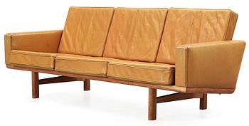 A Hans J Wegner oak and brown leather sofa,