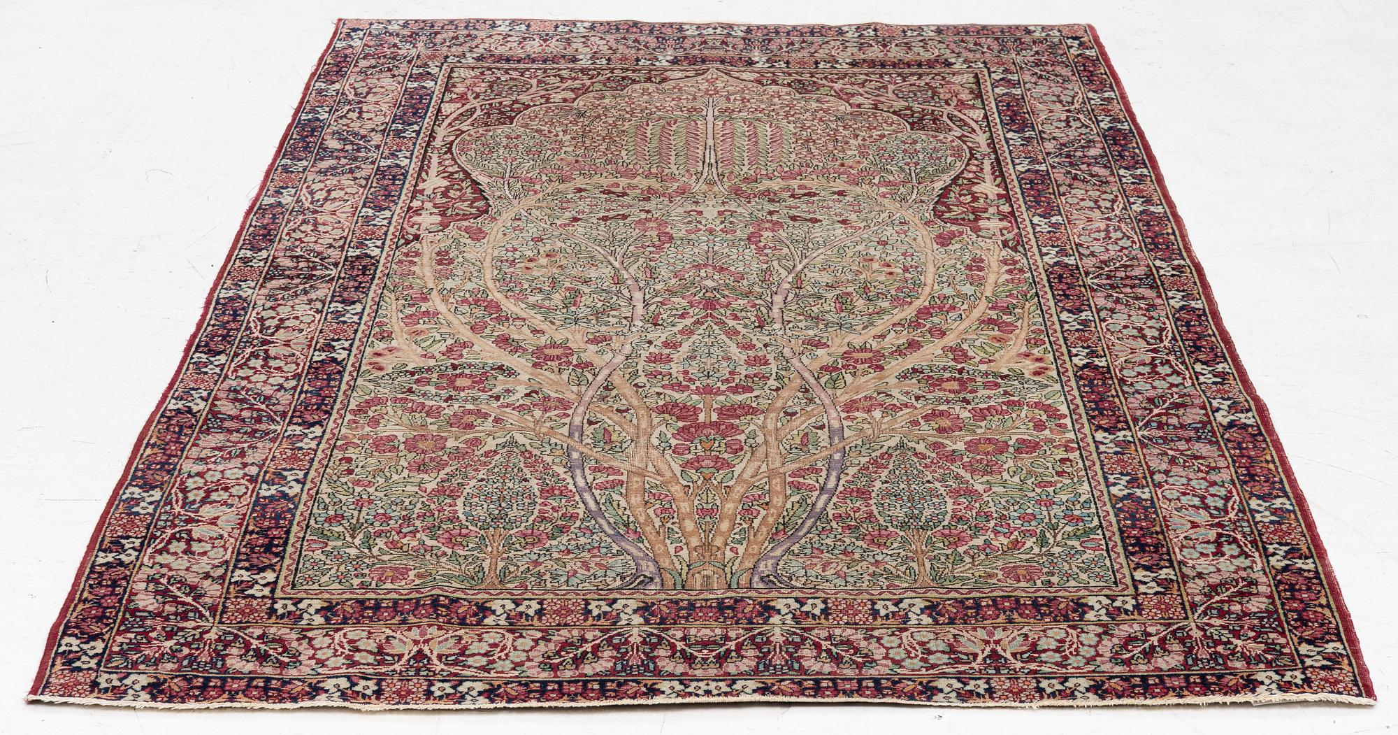 An antique Kirman rug, south Persia, c. 220 x 140 cm.