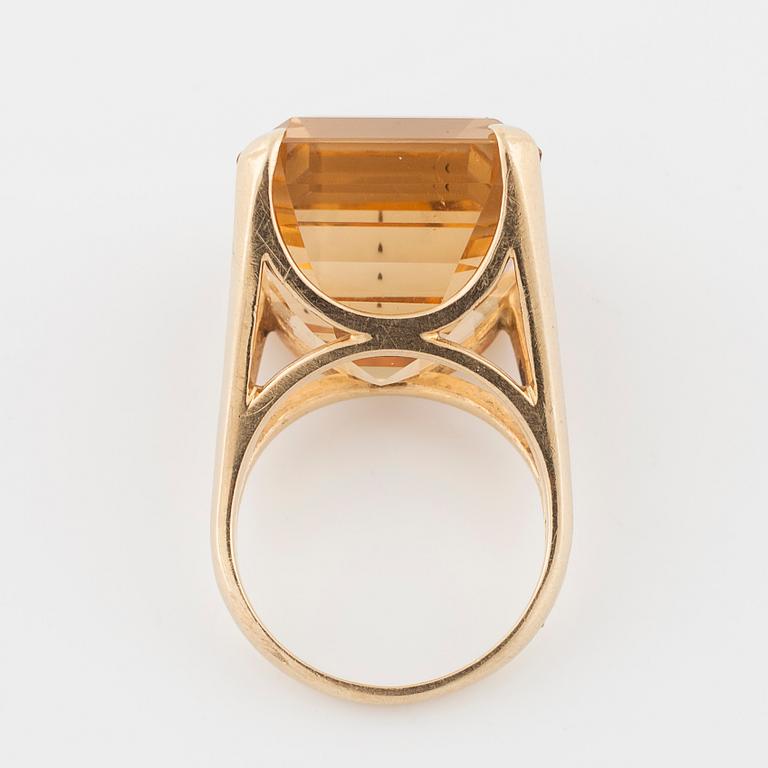 An emerald cut citrin ring.