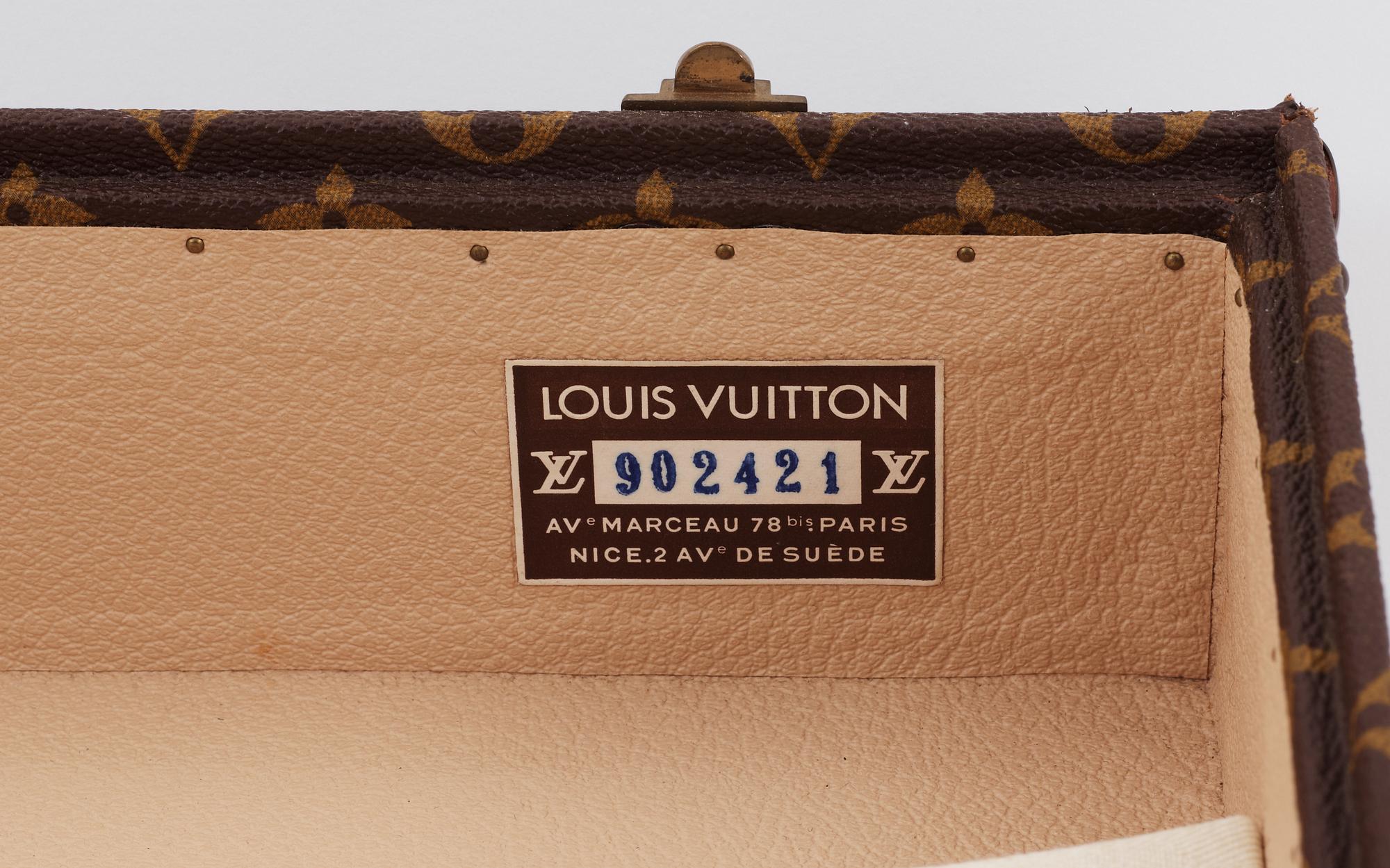 A monogram canvas suitcase by Louis Vuitton.
