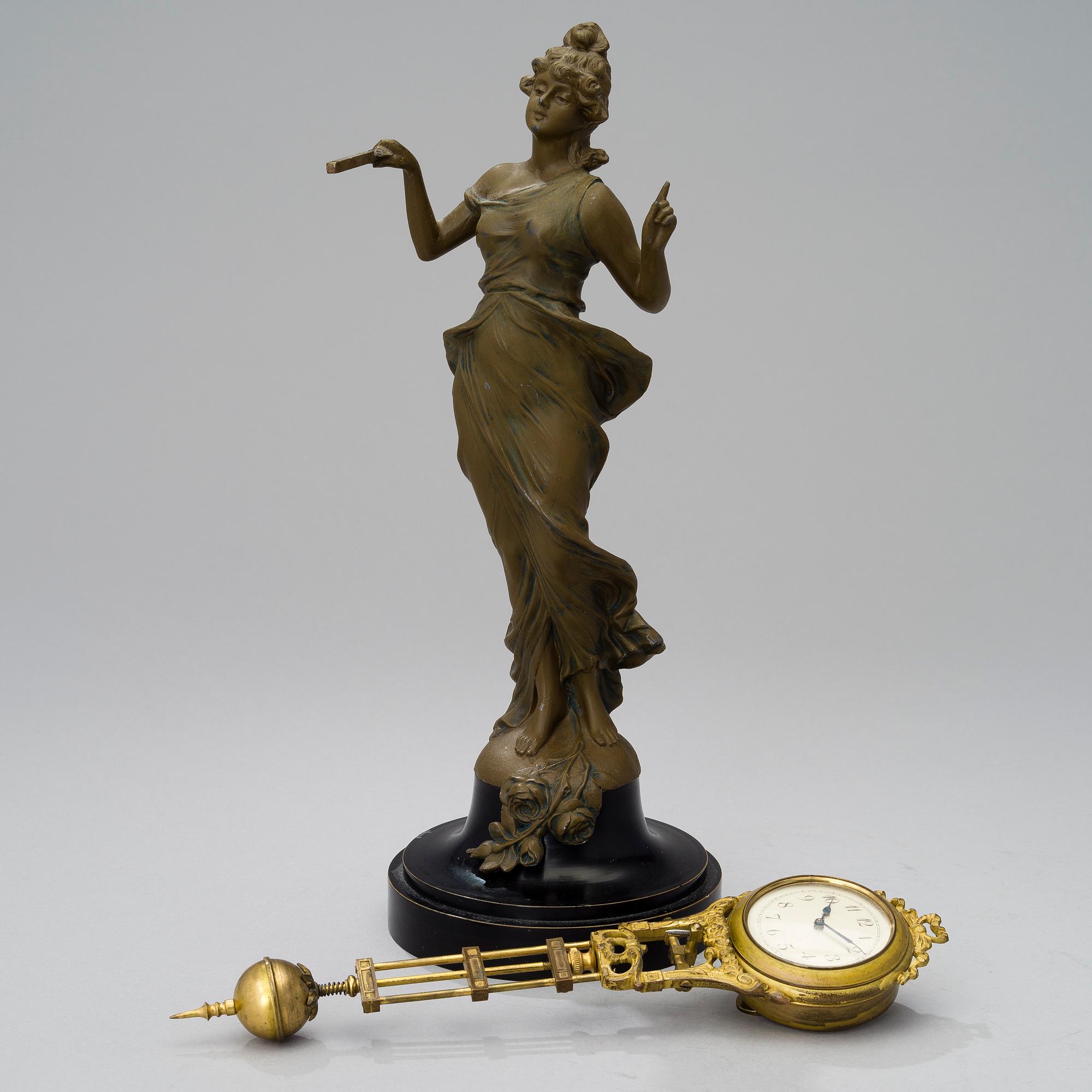 A 1930s Junghans swinger clock with girl sculpture.