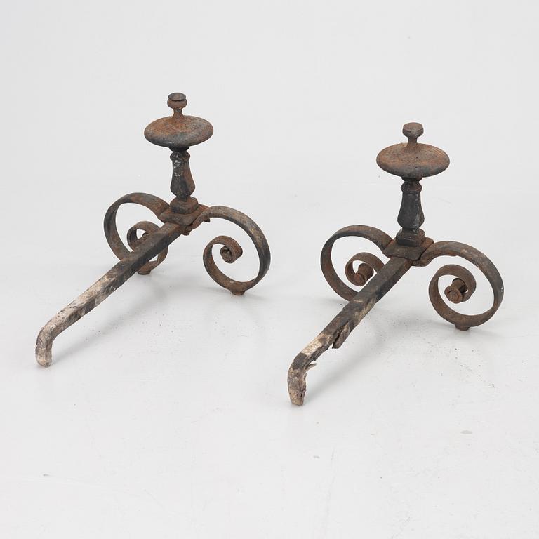 A pair of wrought iron fire dogs.