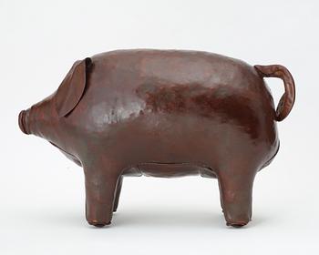 A brown leather figure of a pig by Svenskt Tenn.