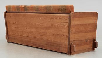 An Axel Einar Hjorth 'Lovö' stained pine sofa, Nordiska Kompaniet, Sweden 1930's.