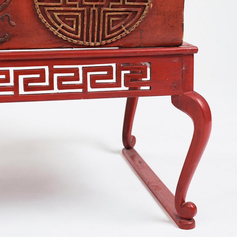 A red lacquered chest on a later stand, late Qing dynasty, 19th Century.