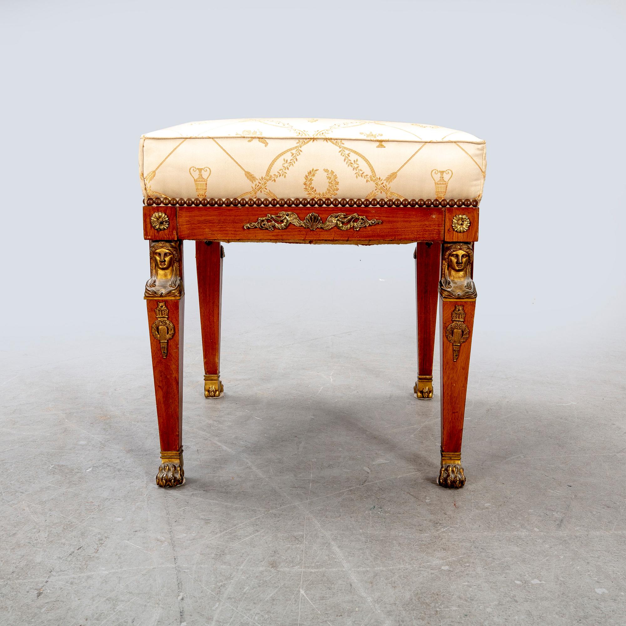 An Empire style mahogany stool around 1900.