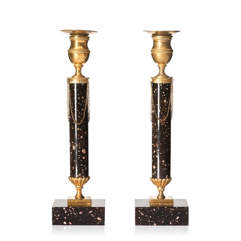 A pair of late Gustavian porphyry and gilt brass candlesticks, circa 1800.