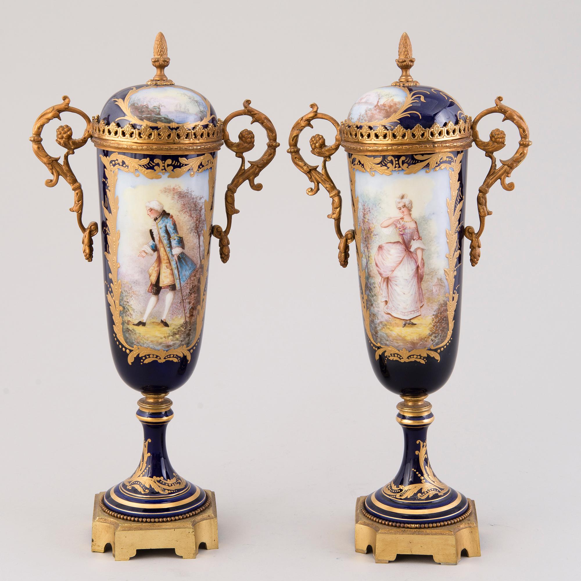 Pair of Sevres Chateau des Tuileries porcelain lidded urns, mid-19th century.
