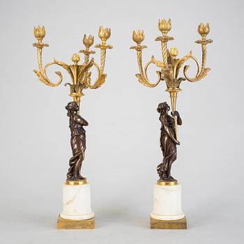 A pair of 19h Century Louis XVI style three-light candelabra in bronze and marble.