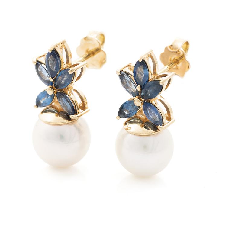 18K gold earrings with cultured Akoya pearls and navette-cut sapphires.