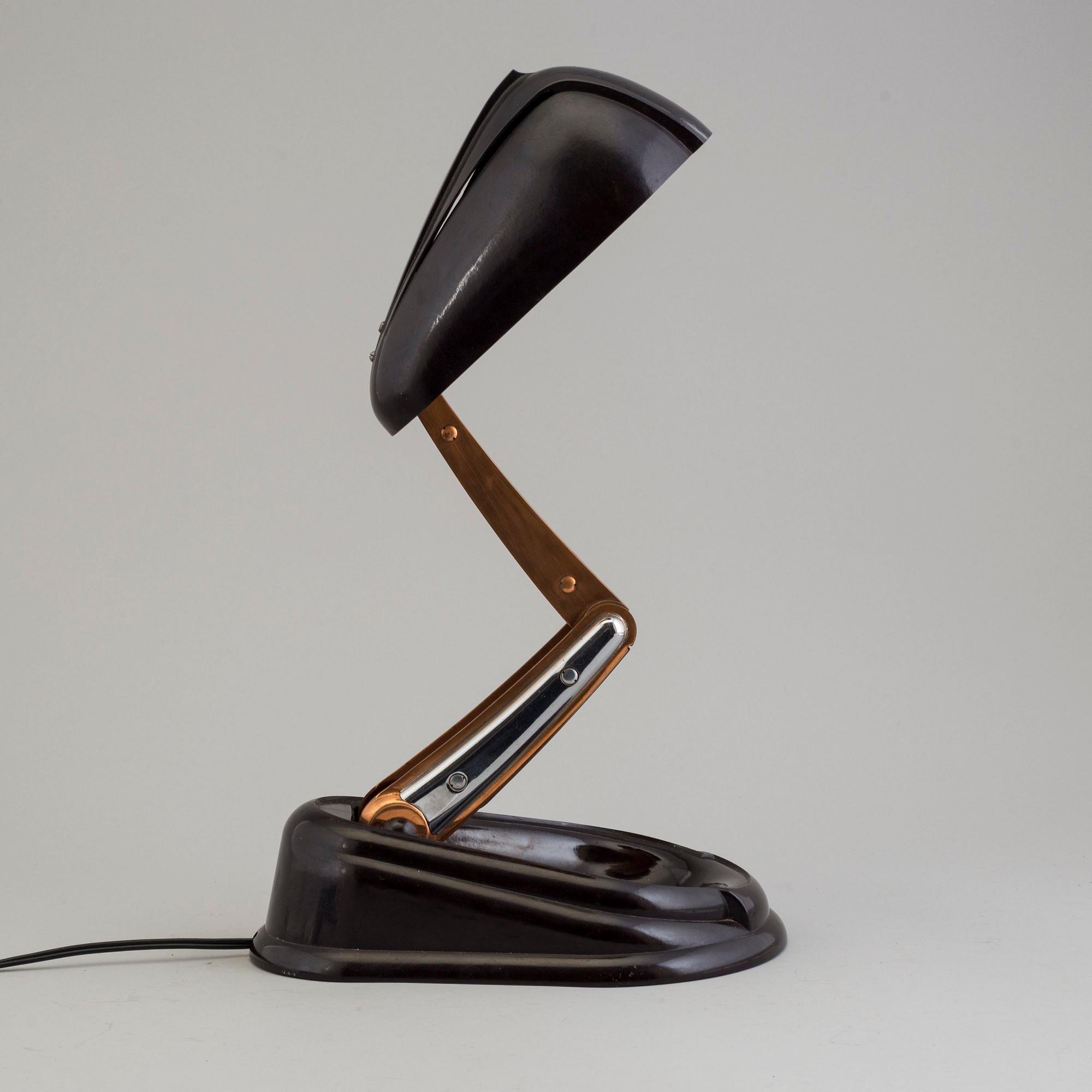 a bakelite and metal table 'Bolide' table lamp, by JUMO, 1940's.