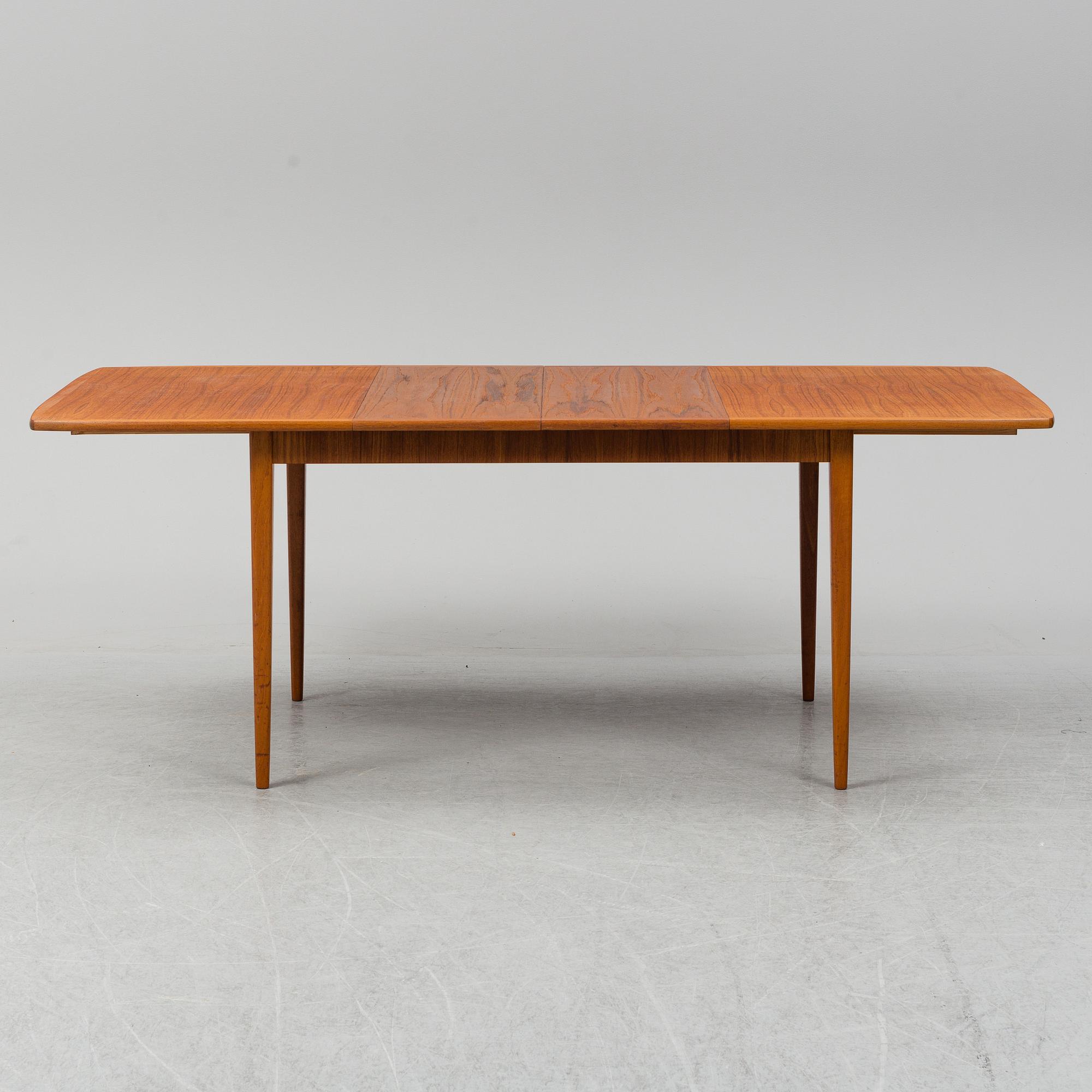 A second half of the 20th century teak veneered dining table.