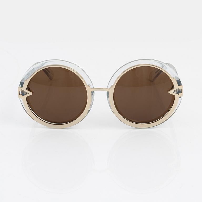 Karen Walker, a pair of "Orbit" sunglasses.