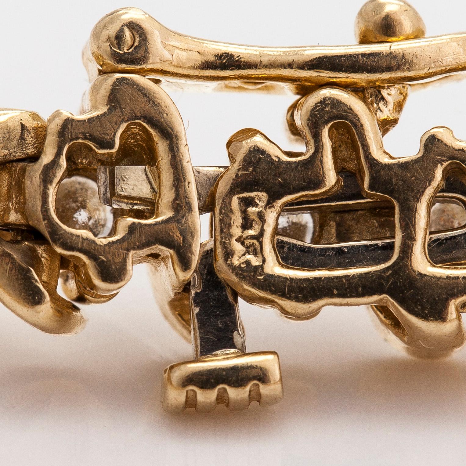 A 14K gold tennis bracelet, with brilliant-cut diamonds.