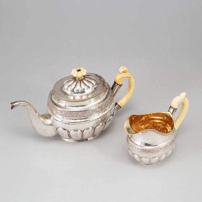 A Russian silver teapot and a parcel gilt silver creamer, Gustav Lindgren and Elias Modig, St Petersburg 1826-27.