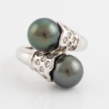 Cultured black pearl and brilliant cut diamond cross over ring.