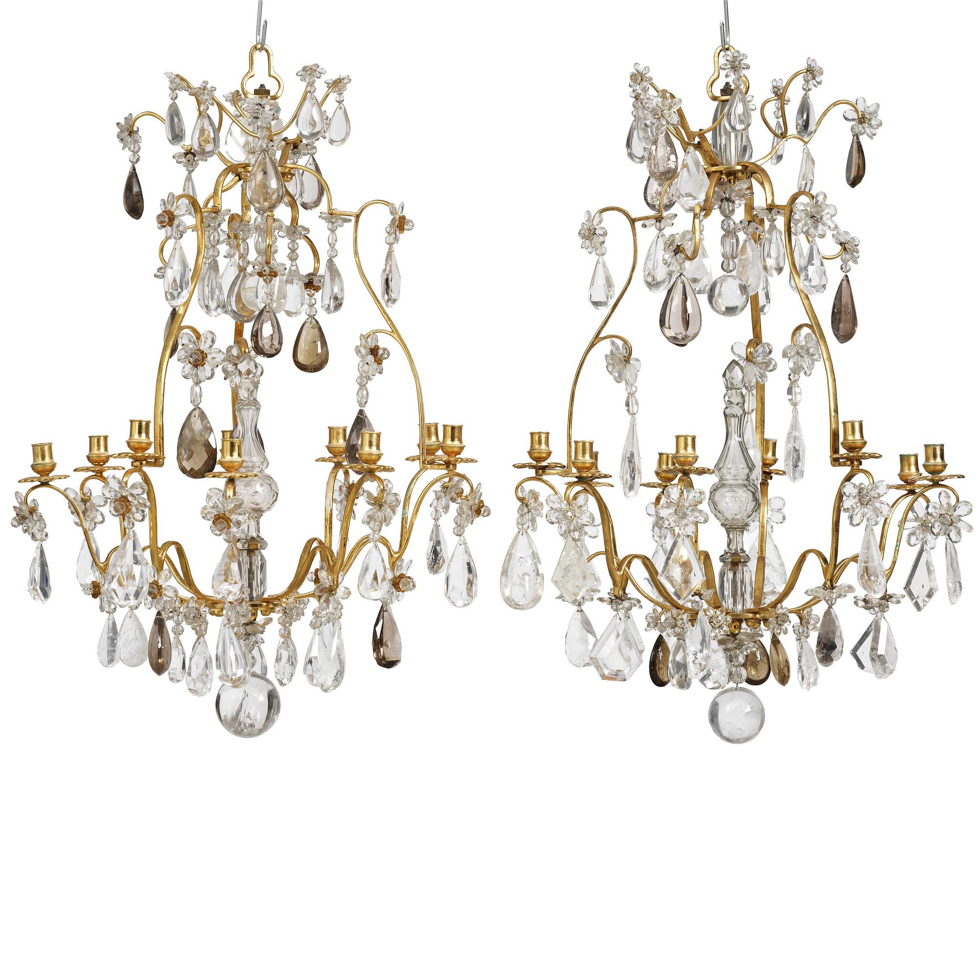 A near pair of Franch Louis-XV-style nine-branch gilt bronze and rock crystal chandeliers, later part 19th century.