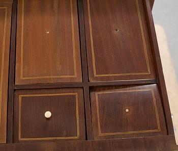 An empire chest of drawers, 19th century.