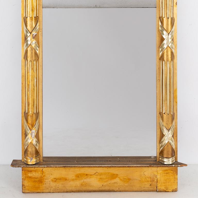 An Empire mirror, first half of the 19th century.