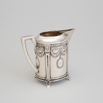 A set of three silver objects (coffeepot, creamer and sugarbowl, CG Hallberg and GAB, Stockholm 1907. Weight ca 1226 gr.