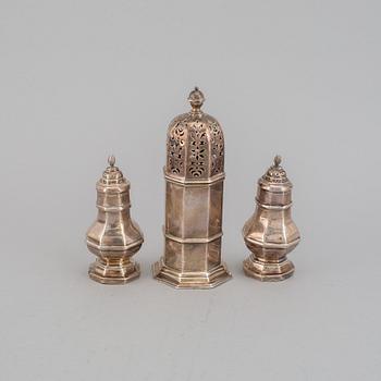 A pair of silver salts and a sugar shaker, including S W Smith & Co, London 1906.