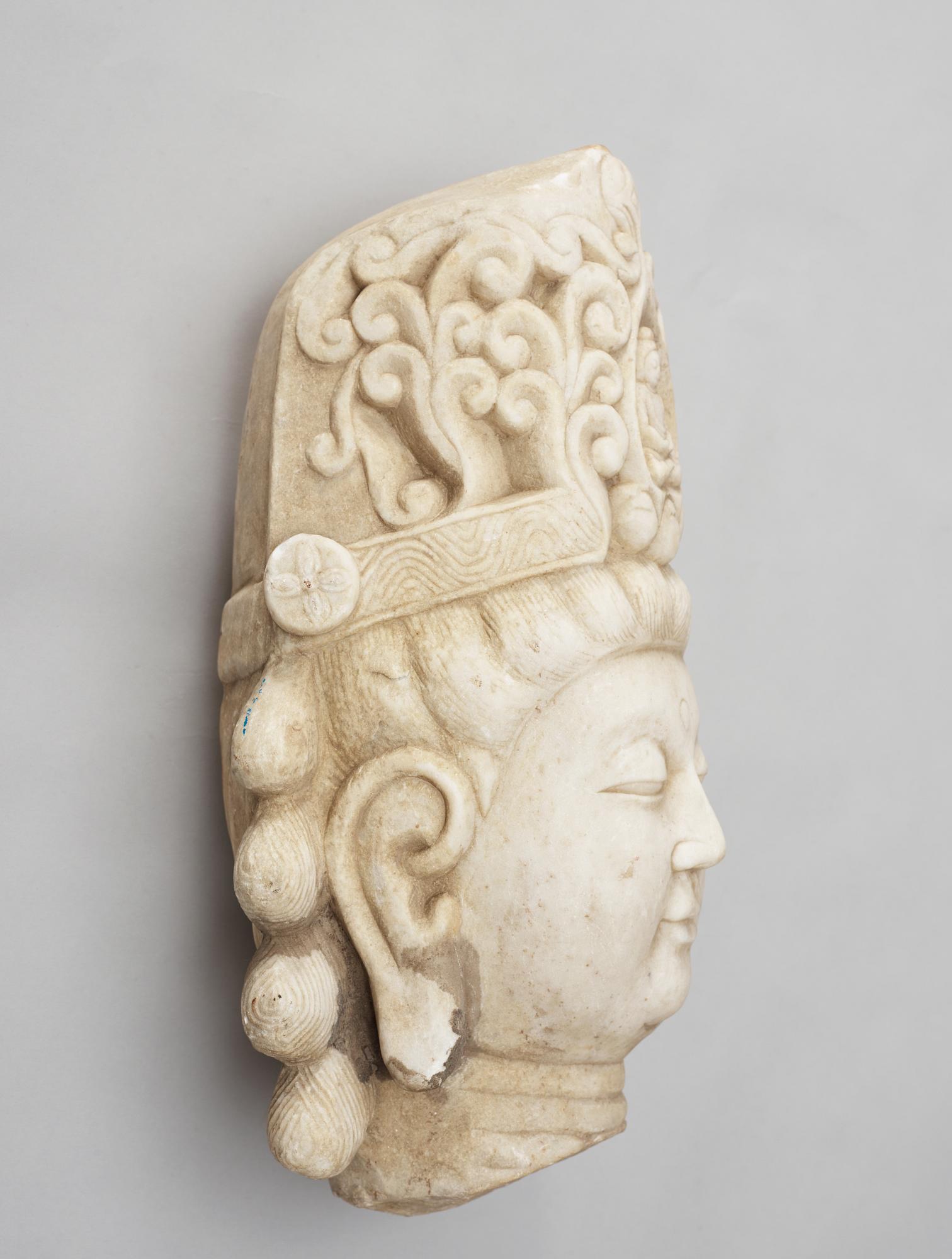 A white stone 20th century buddha head.