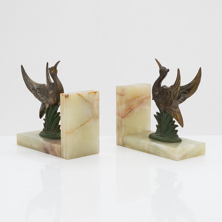 A pair of alabaster and  patinated metal Art Deco bookends from the first half of the 20th Century.