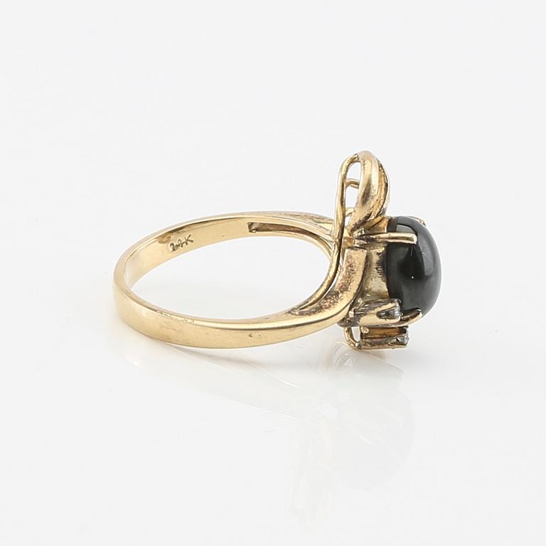 Ring and earrings in 14K gold with round brilliant-cut diamonds and likely natural black star sapphires.