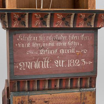 a painted grandfather-clock dated 1823.