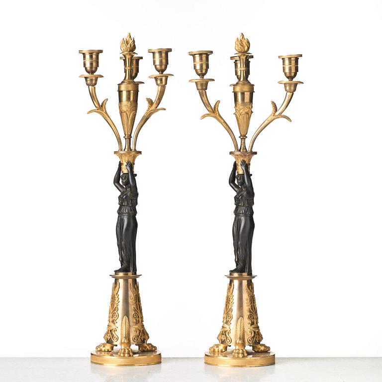 A pair of French Empire early 19th century three-light candelabra.