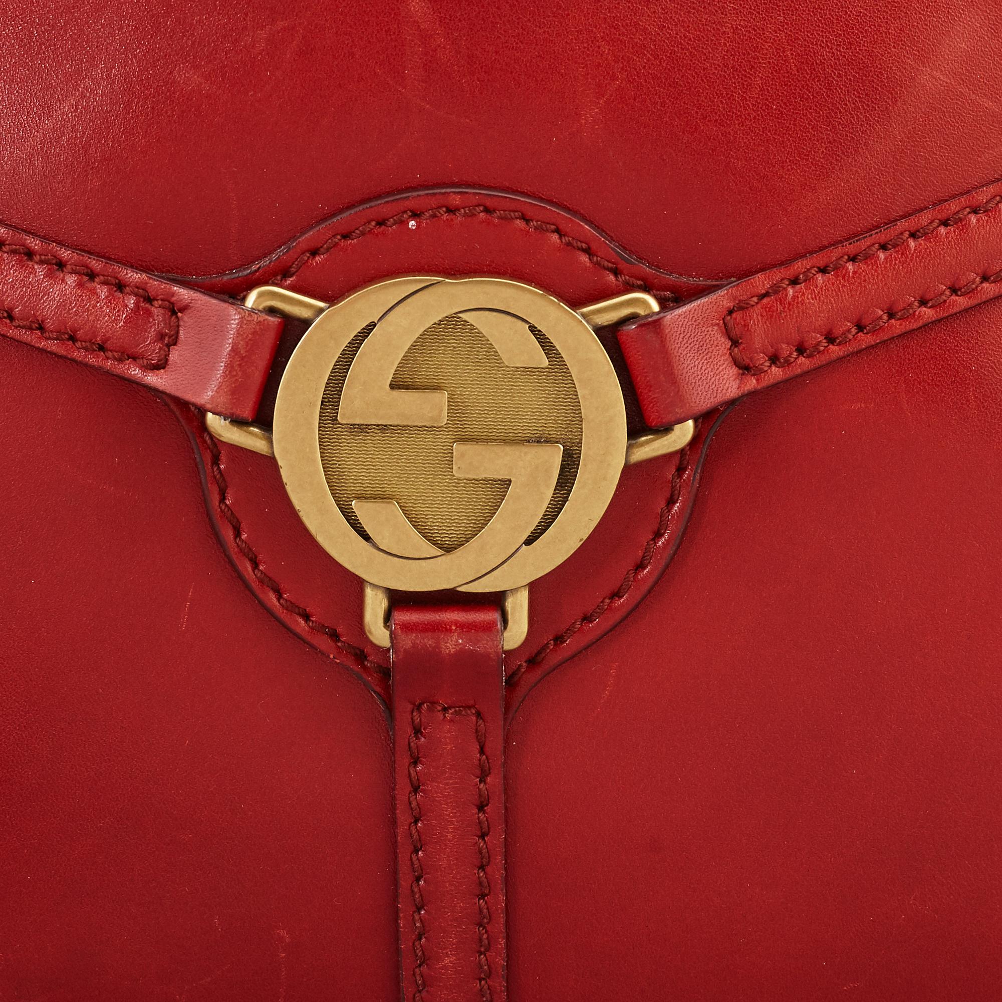 GUCCI, a red leather crossbody bag.