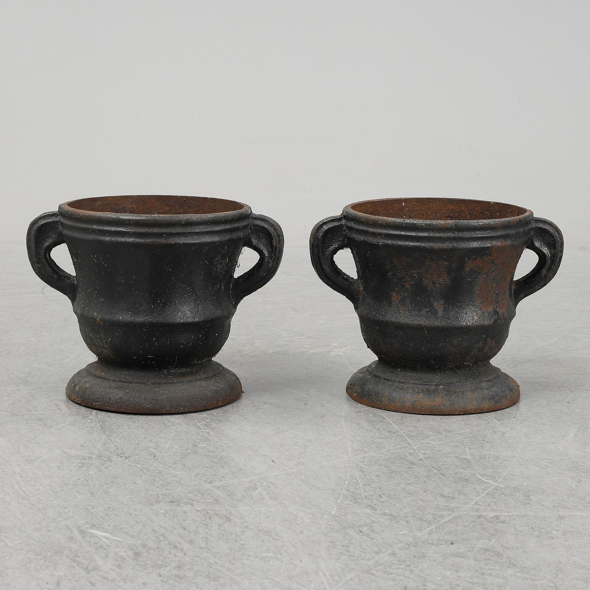 A 19th  century pair of cast iron flower pots.