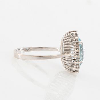 Ring 18K white gold set with an oval faceted aquamarine and round brilliant-cut diamonds.
