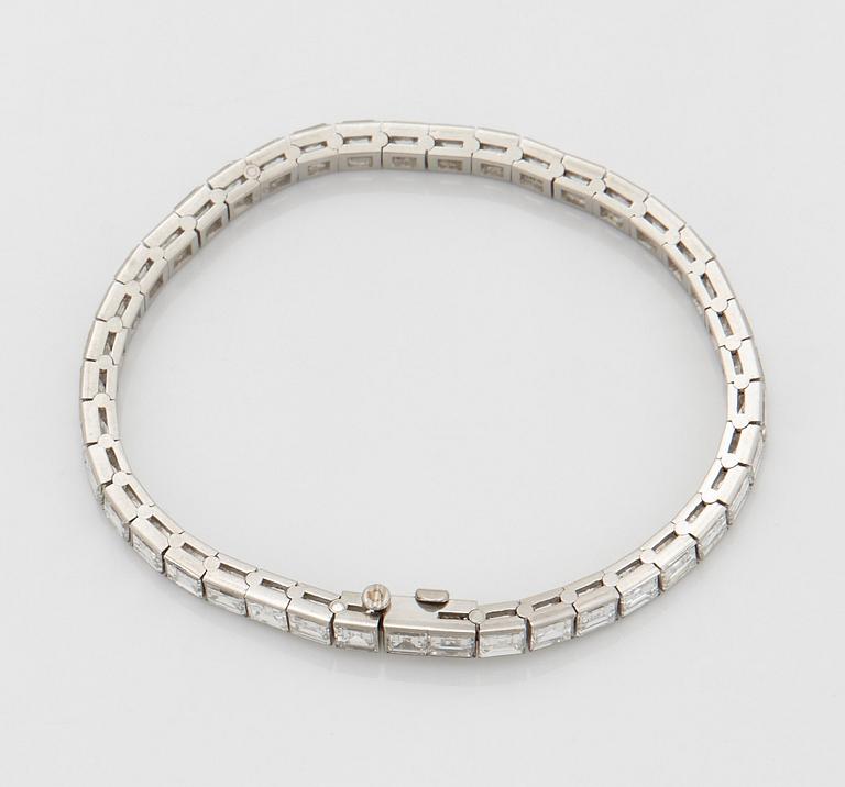 A platinum bracelet set with carré cut diamonds.