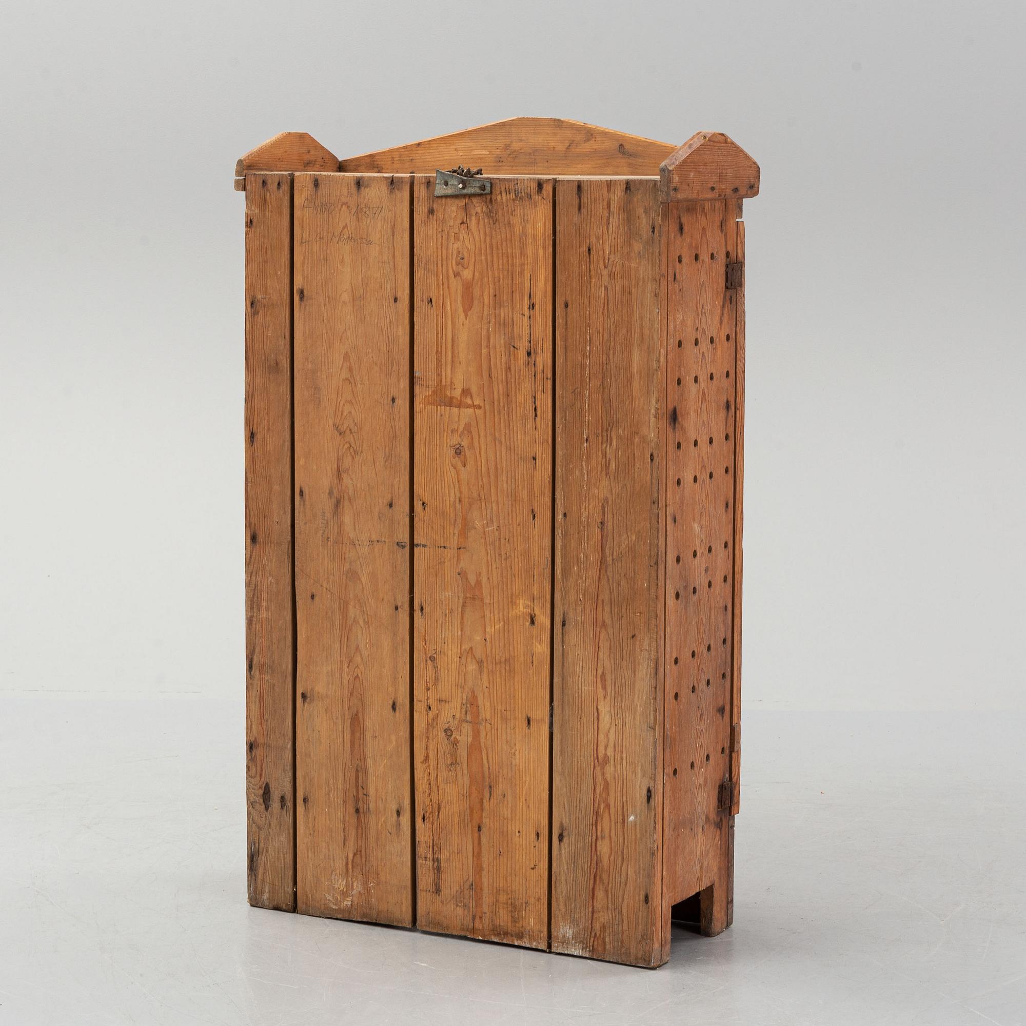 A late 19th century pine cupboard for eggs.