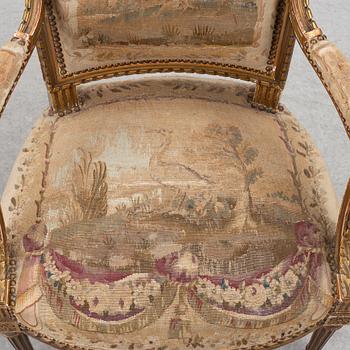 A pair of Louis XVI-style armchairs, late 19th century with 18th century fabric.