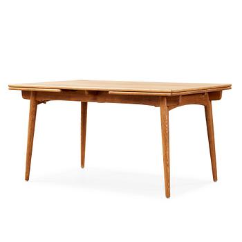 A Hans J Wegner oak dinner table 'AT 312' and four oak and black leather chairs, C M Madsen, Denmark 1950-60's.