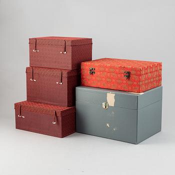 A group of five Chinese fabric clad boxes.